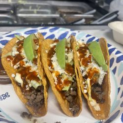 3 Crispy tacos...ground beef ,queso fresco, sour cream, lettuce,avocado and red salsa...
