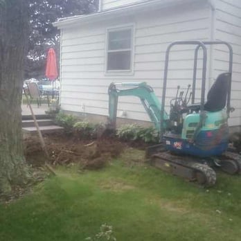 Jesse's Landscaping - a small excavator in front of a house - Landscaping Near Me - Greenwich, Ohio Jesse's Landscaping - a small excavator in front of a house - Landscaping Near Me - Greenwich, Ohio