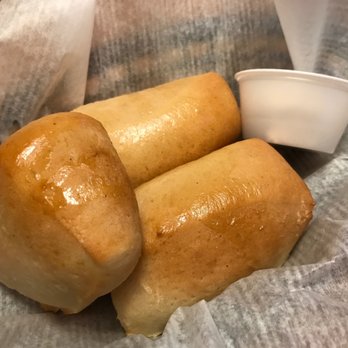 Texas Roadhouse - two rolls of bread and a cup of coffee - Steakhouses Near Me - Champaign, Illinois