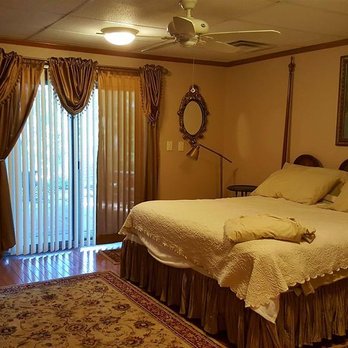 Homestead Solutions - a bedroom with a bed, dresser, and tv - Home Cleaning Near Me - Hartwell, Georgia Homestead Solutions - a bedroom with a bed, dresser, and tv - Home Cleaning Near Me - Hartwell, Georgia