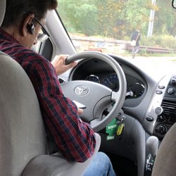 Scooters Taxi & Rides - Driver on Facebook while driving.