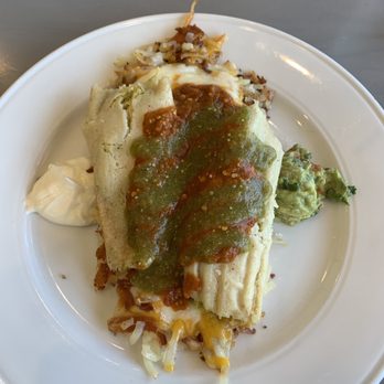 The Jagged Fork - Chicken tamales over cheesy hash browns served with a side of eggs, not pictured. Very spicy! - Waffles Near Me - Lathrup Village, Michigan The Jagged Fork - Chicken tamales over cheesy hash browns served with a side of eggs, not pictured. Very spicy! - Waffles Near Me - Lathrup Village, Michigan