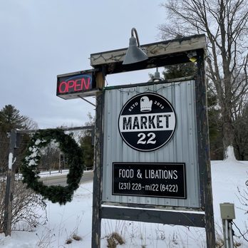 Market 22 - a sign in the snow - Pizza Near Me - Maple City, Michigan