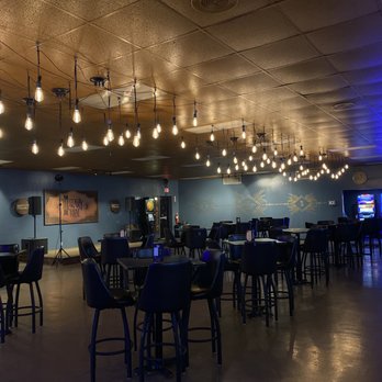 The Library Riot - tables and chairs in a restaurant - Cocktail Bars Near Me - Lake Charles, Louisiana