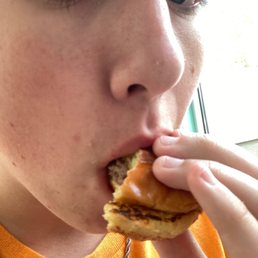 a woman eating a hamburger a woman eating a hamburger