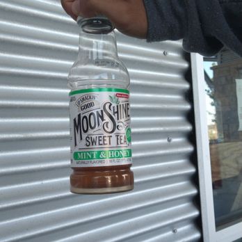 Proof Liquor & Deli - a person holding a bottle of sweet tea - Delis Near Me - Buda, Texas Proof Liquor & Deli - a person holding a bottle of sweet tea - Delis Near Me - Buda, Texas