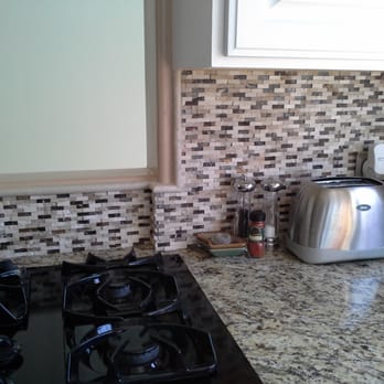 Huezo Tile & Marble - a kitchen counter with a toaster and toaster - Flooring Near Me Huezo Tile & Marble - a kitchen counter with a toaster and toaster - Flooring Near Me