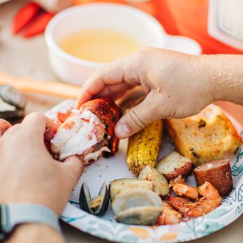 Topsail Steamer - a plate of food being held by a person - Seafood Near Me - Sea Isle City, New Jersey Topsail Steamer - a plate of food being held by a person - Seafood Near Me - Sea Isle City, New Jersey