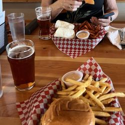 Fox Mountain Brewing Co. - Chicken Sandwich in foreground, the wrap and yam fries at the back. Drinks are Jim's Pale Ale