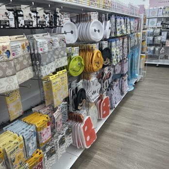 Daiso - Merchandise - The image shows a retail shelf stocked with Disney-themed paper towels, plates, and accessories, including character designs like Mickey Mouse and Minnie Mouse. - Department Stores Near Me - Jurupa Valley, California