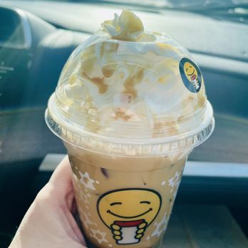 Scooter's Coffee - a hand holding a cup of iced coffee - Coffee & Tea Near Me - Prior Lake, Minnesota