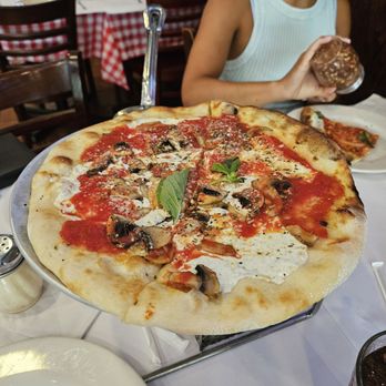 Grimaldi's Pizzeria - Lunch Special 12 inch pizza with additional mushroom topping. Not pictured: sweetened iced tea. - Pizza Near Me - Garden City, New York Grimaldi's Pizzeria - Lunch Special 12 inch pizza with additional mushroom topping. Not pictured: sweetened iced tea. - Pizza Near Me - Garden City, New York