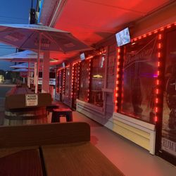 Rum Runners - Outside porch with tvs