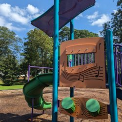Playground with toddler and older kid play and swings with parking at Waffle House