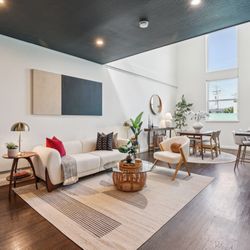 Casa Di Vita Staging - Living room with high ceilings in a loft condo