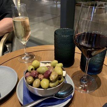 Narrative - Prosecco, Greek Wine (Skouras Saint George Aghiorghitiko), and appetizer olives. - New American Near Me - Denver, Colorado