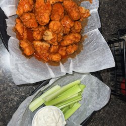 Buffalo Bobs Restaurant - Boneless hot buffalo flavored chicken wings (breaded pieces of chicken) with celery and bleu cheese dressing.