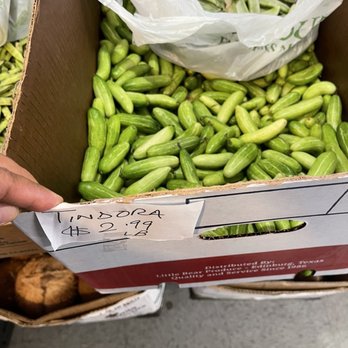 India Bazaar - a person holding a box of green beans - International Grocery Near Me - Upland, California