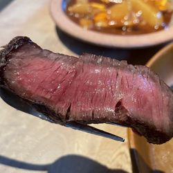 Isidore - Velvety, perfectly medium-rare slice of dry-aged Wagyu ribeye. Sliced with surgical precision!