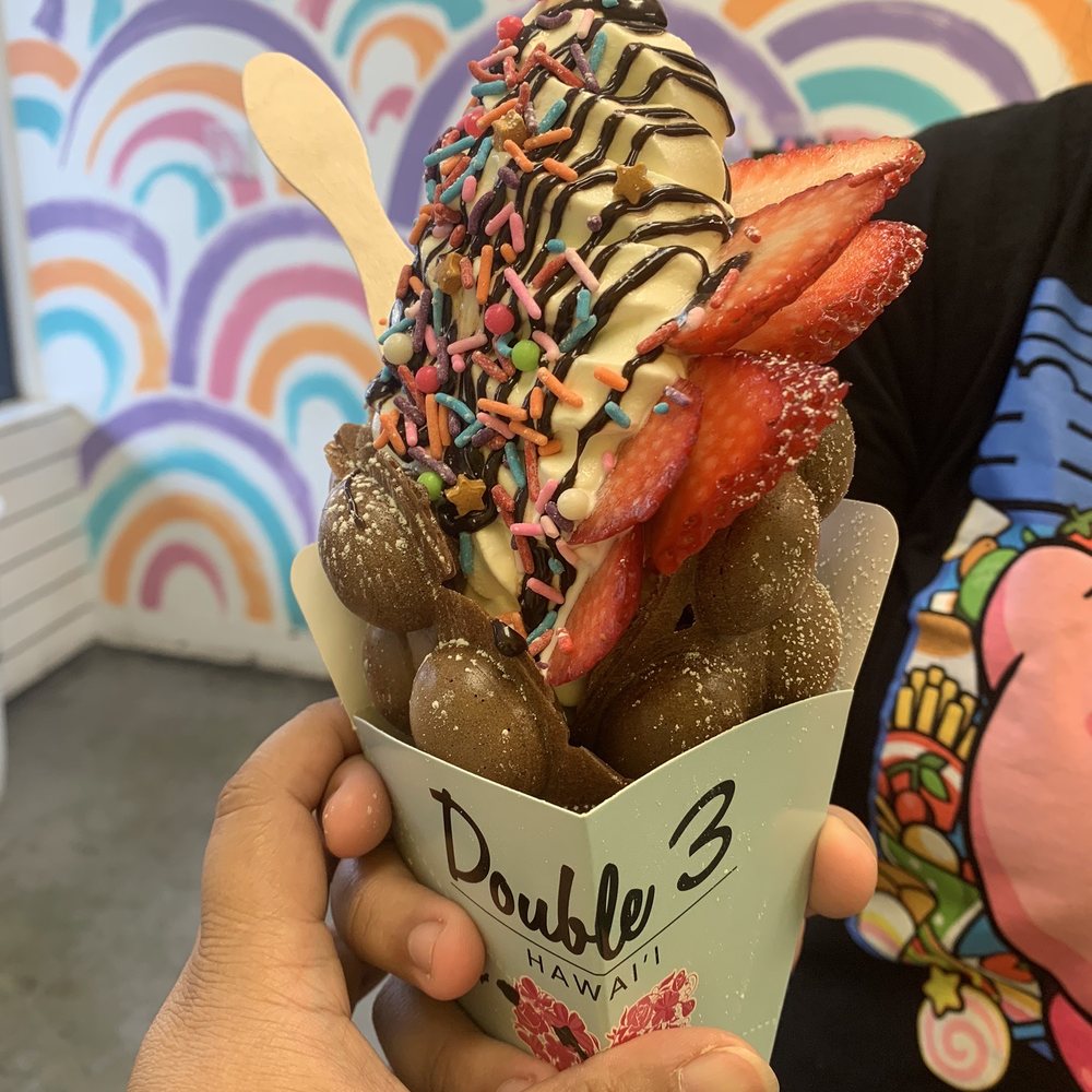 Double Three - Chocolate bubble waffle with vanilla ice cream, rainbow sprinkles, strawberries, and chocolate syrup - Ice Cream & Frozen Yogurt Near Me - Honolulu, Hawaii Double Three - Chocolate bubble waffle with vanilla ice cream, rainbow sprinkles, strawberries, and chocolate syrup - Ice Cream & Frozen Yogurt Near Me - Honolulu, Hawaii