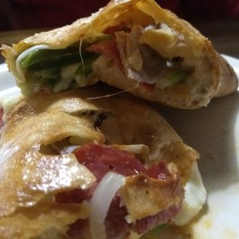 Mama's Pizza - The inside of the stromboli filled with fresh veggies, meat and cheese. - Pizza Near Me - Alpharetta, Georgia