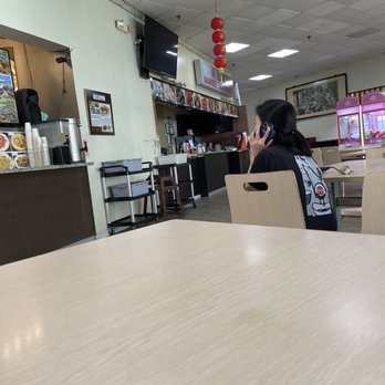 Chong Qing Hot Pot - Food court; woman waiting for her order - Szechuan Near Me - Chamblee, Georgia