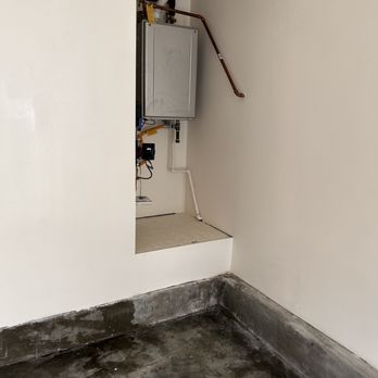 Richie's Handyman Services - a water heater in the corner of a room - Handyman Near Me Richie's Handyman Services - a water heater in the corner of a room - Handyman Near Me