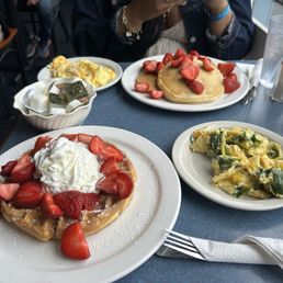 Strawberry waffles and pancakes with scrambled eggs