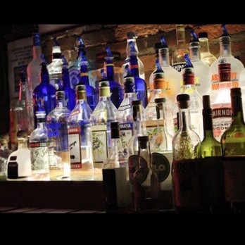 Cafe Nine - bottles of alcohol lined up on a bar - Bars Near Me - New Haven, Connecticut