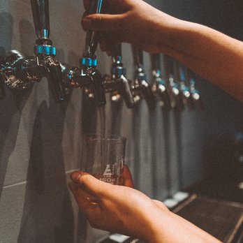 St Vitus - a person filling a glass of water - Cocktail Bars Near Me - Tulsa, Oklahoma