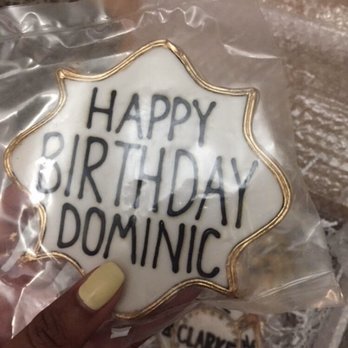 Tiny Kitchen Treats - a hand holding a decorated cookie - Bakeries Near Me - Brooklyn, New York