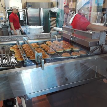 Krispy Kreme - The 2nd to last step: lightly frying the donuts in oil before their icing shower! - Donuts Near Me - Carolina, Puerto Rico