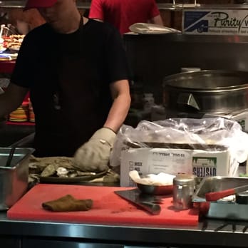 Dragon Legend - Guy shucking oysters with a hugggggeee glove on. Safety first lol - Chinese Near Me - Markham, Ontario