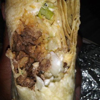 Tacos Si Senor - a hand holding a burrito - Mexican Near Me - Lancaster, California Tacos Si Senor - a hand holding a burrito - Mexican Near Me - Lancaster, California