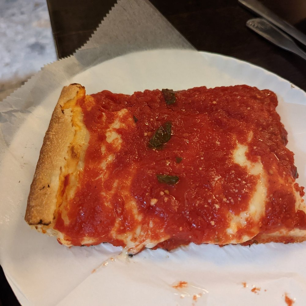 Upside down Sicilian slice (sauce on top and cheese under that) Upside down Sicilian slice (sauce on top and cheese under that)