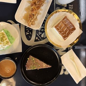 Sana'a Cafe - Table on left side with several desserts and drinks - Coffee & Tea Near Me - Elk Grove, California Sana'a Cafe - Table on left side with several desserts and drinks - Coffee & Tea Near Me - Elk Grove, California