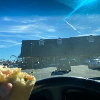 Beach Hut Deli - a person holding a sandwich - Sandwiches Near Me - Auburn, California Beach Hut Deli - a person holding a sandwich - Sandwiches Near Me - Auburn, California
