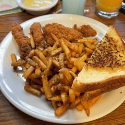Chicken tenders with seasoned fries and Slice of French Toast
