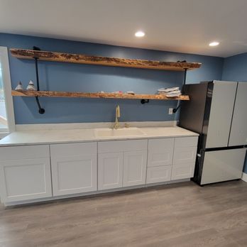 McBride Construction - a kitchen with blue walls and white cabinets - Decks & Railing Near Me - Snohomish, Washington
