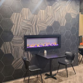 The Locale - New tiled, 2-sided dividing wall with fireplace on each side with 2 large doorways. - American Near Me - Brownsburg, Indiana