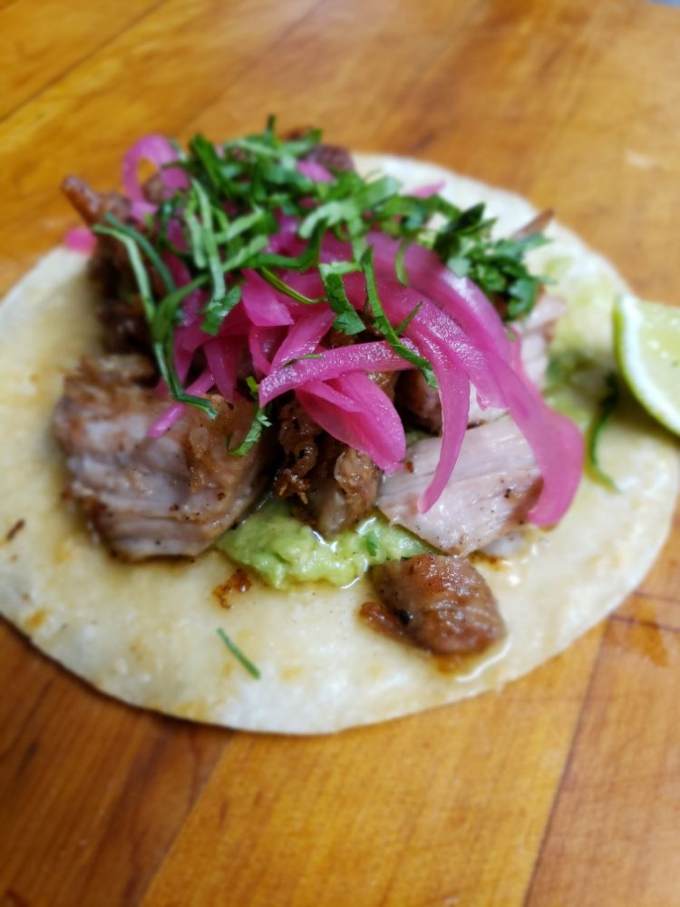 Photo of Un Mundo De Sabor - Austin, TX, United States. Carnitas Taco Slow cooked pork shoulder then seared, crushed avocado, pickled red onions, cilantro ;)