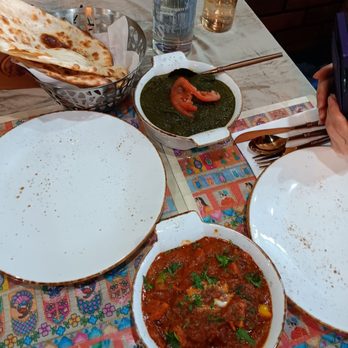 Modern Handi Indian Cuisine - Chicken Tikka masala in the foreground, lamb saag (spinach) towards the back, a basket with 1 naan and an order of rice - Indian Near Me - Vancouver, British Columbia Modern Handi Indian Cuisine - Chicken Tikka masala in the foreground, lamb saag (spinach) towards the back, a basket with 1 naan and an order of rice - Indian Near Me - Vancouver, British Columbia
