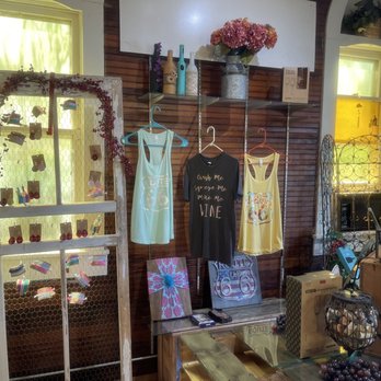 StableRidge Vineyards - a display of wine bottles and t - shirts - Wineries Near Me - Stroud, Oklahoma