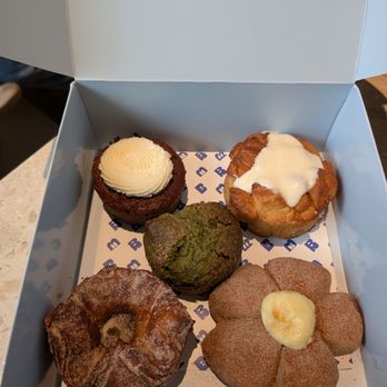 The Bread Club - Carrot cake muffin, morning bun, sweet potato ensayada, kouign amann, and (center) banana matcha muffin. - Coffee & Tea Near Me - Dallas, Texas