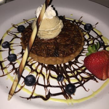 Bentley's Restaurant - Number 1 dessert in the house is this pecan tart, chock-full with pecans! - French Near Me - Charlotte, North Carolina