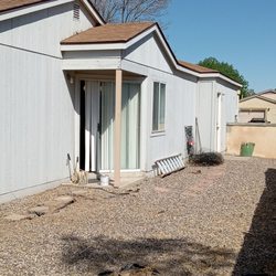 Holes in lawn left undone from habitat of humanity.