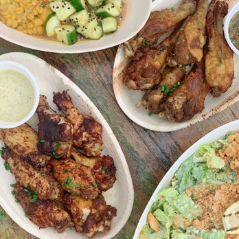 Primal Wings - a variety of foods on a wooden table - Chicken Wings Near Me - Montauk, New York Primal Wings - a variety of foods on a wooden table - Chicken Wings Near Me - Montauk, New York