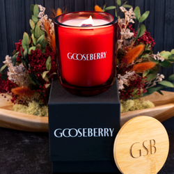 Custom Candles LA - A chic classic red round bottom candle atop a luxurious black box and an engraved lid, all with matching logos.