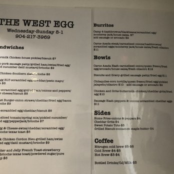 The West Egg - Menu on the wall. - The menu from The West Egg features breakfast items, sandwiches, burritos, bowls, sides, and coffee, with prices and descriptions. - Coffee & Tea Near Me - St. Augustine, Florida