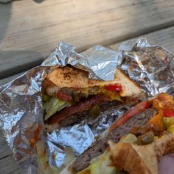 Juicy J's Lemonade And Eatery - Burger with "everything" on it on bread